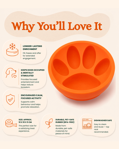 An orange dog paw enrichment toy shown on a beige infographic background with text callouts describing benefits such as longer-lasting enrichment, mental stimulation, and durable pet-safe material.