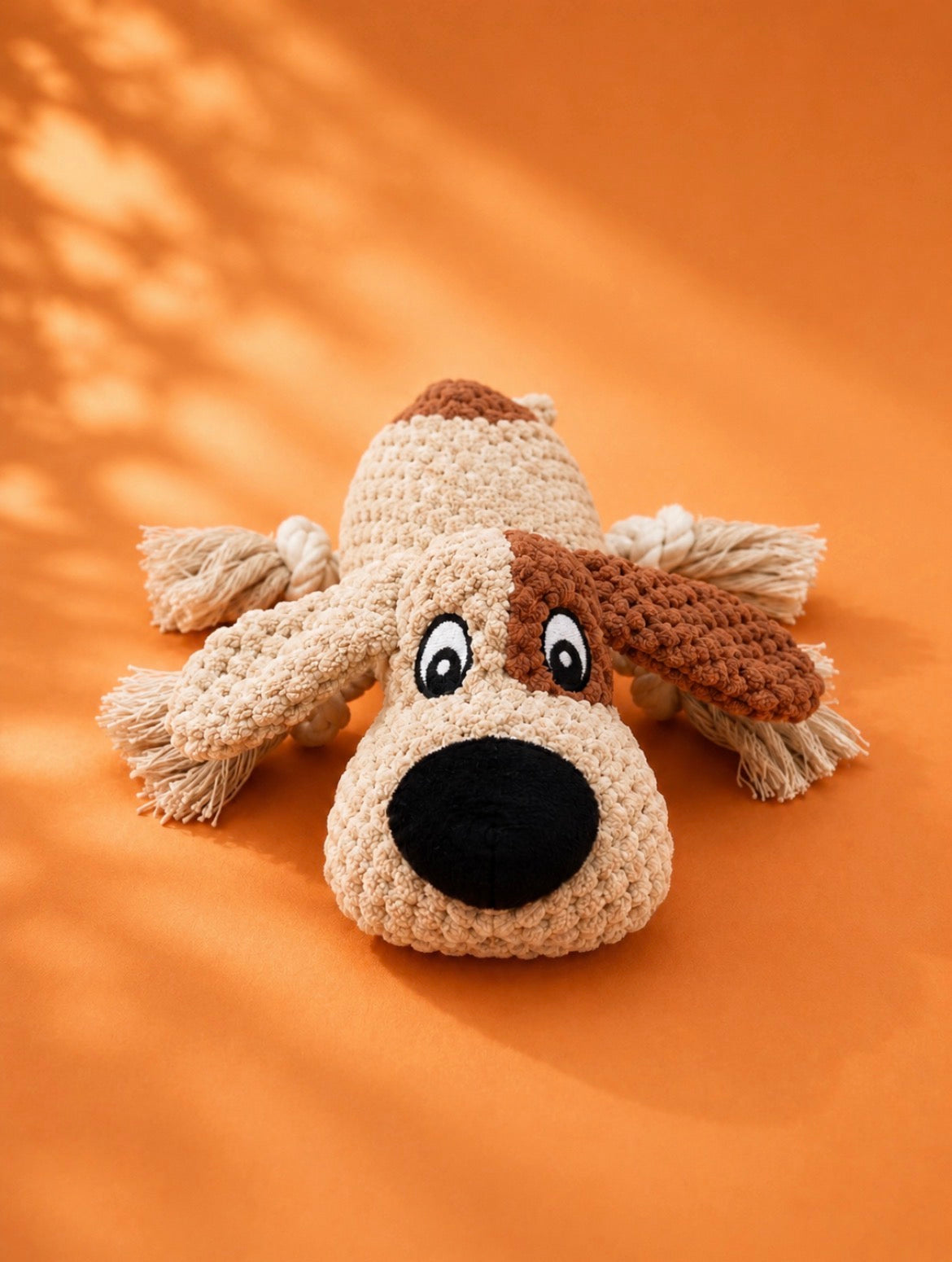 Busy Buddy interactive dog toy featuring a plush body, rope legs and squeaker for enrichment, tug and fetch games.