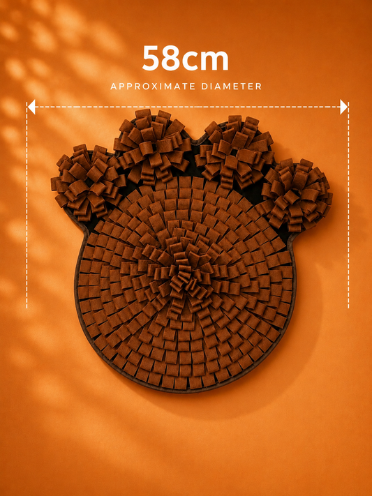 Brown paw-shaped dog snuffle mat measuring approximately 58cm in diameter, displayed on an orange background.